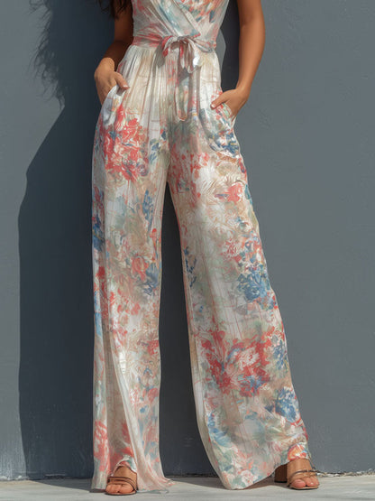 Mono Boho Resort de Satén Floral con Cuello Halter, Diseño Cruzado y Pierna Ancha