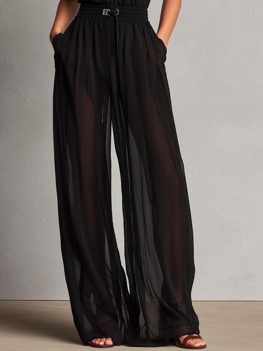 Mono Elegante Negro de Pierna Ancha con Cuello Halter Alto y Detalles Semitransparentes