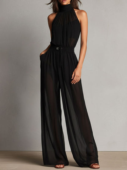 Mono Elegante Negro de Pierna Ancha con Cuello Halter Alto y Detalles Semitransparentes