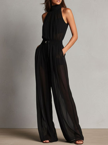 Mono Elegante Negro de Pierna Ancha con Cuello Halter Alto y Detalles Semitransparentes